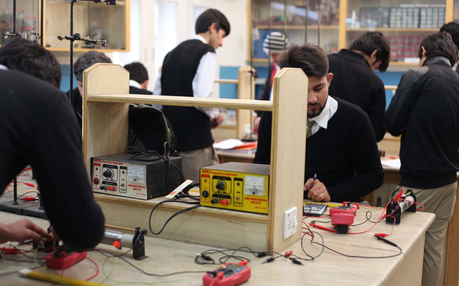 Students working on electronics and IT projects in a technical training lab