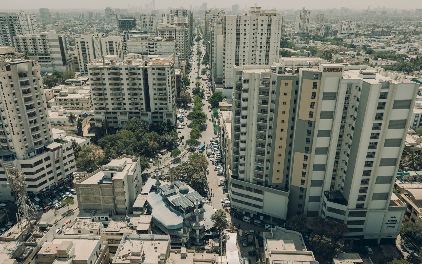 Aerial view of the Karachi skyline with high-rise apartment blocks and busy roads