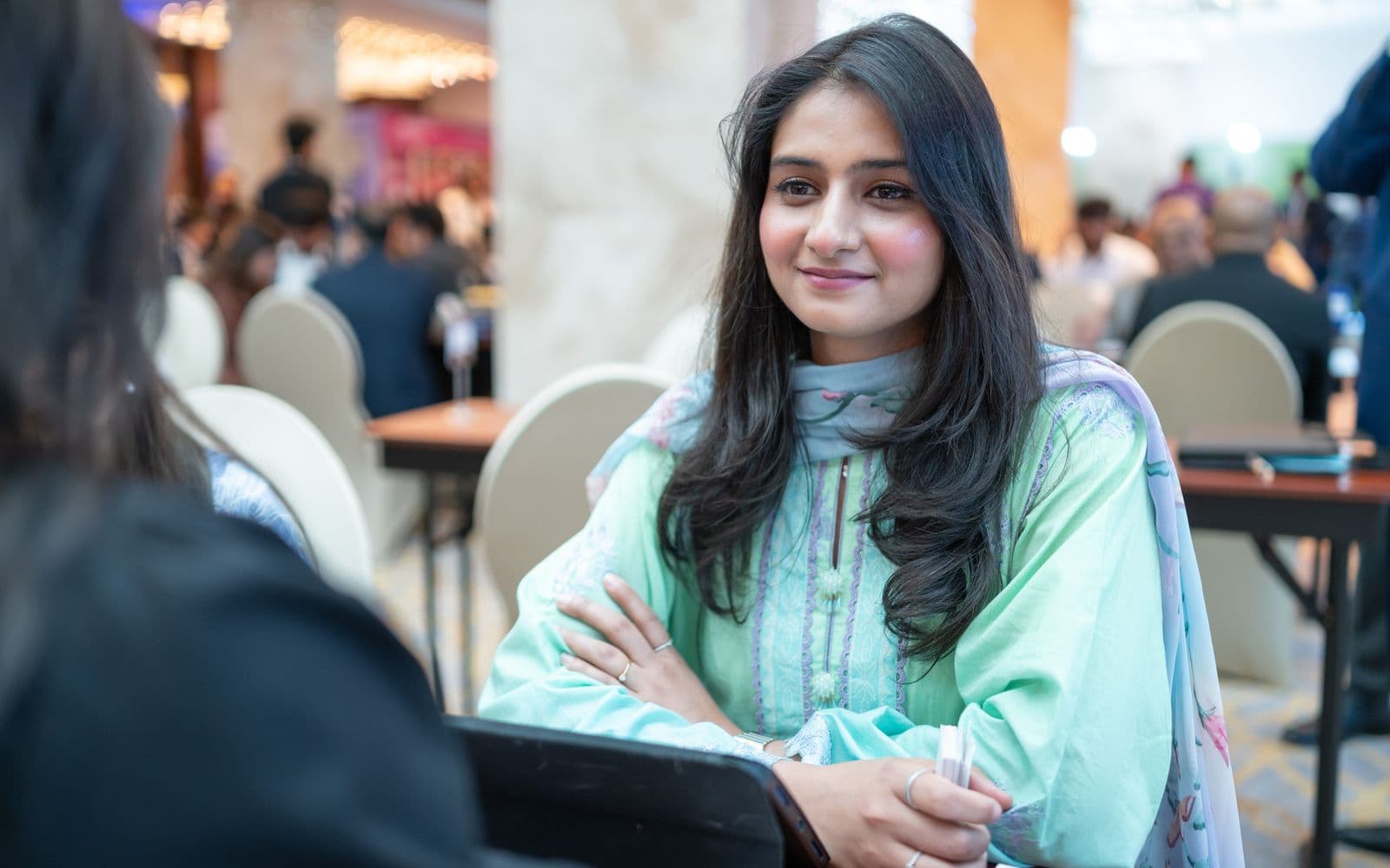 Pakistani businesswoman in traditional dress at a corporate networking event