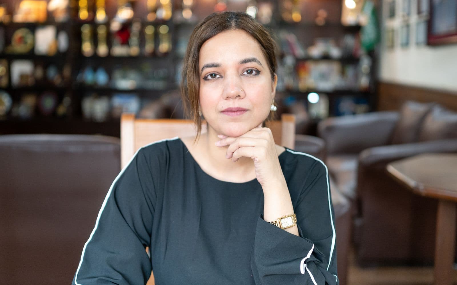 Pakistani HR professional seated in a modern office