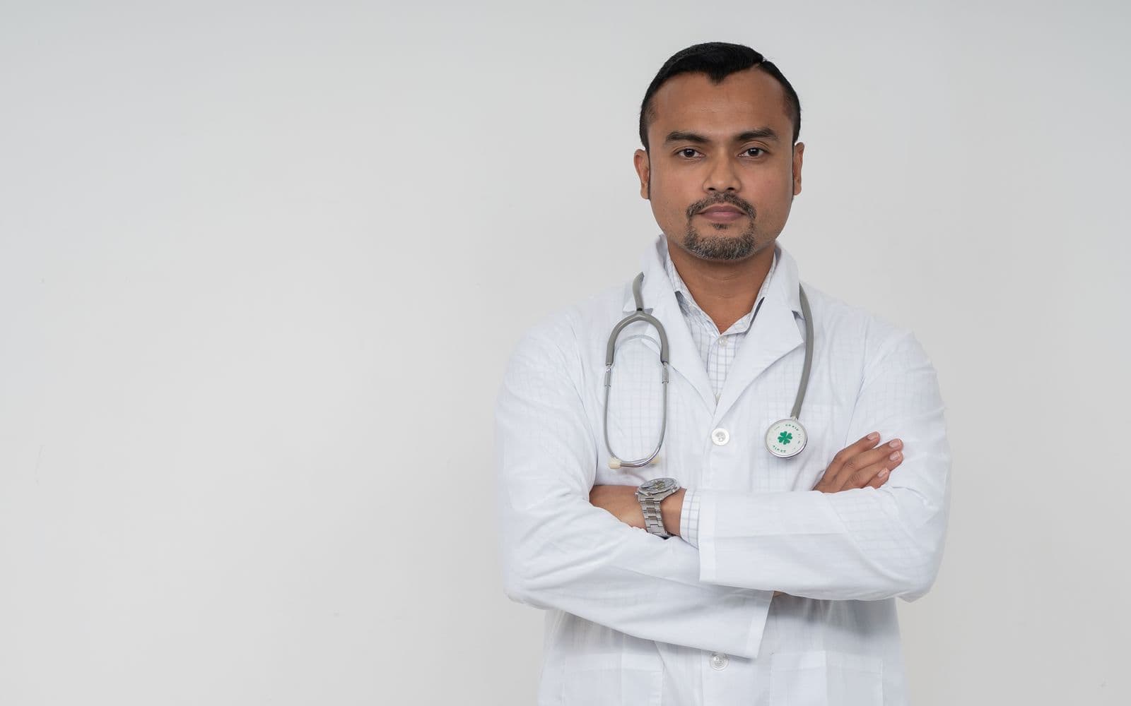 South Asian doctor in a white coat with a stethoscope